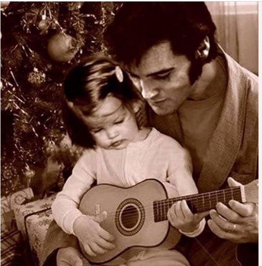Elvis teaching Lisa to play guitar